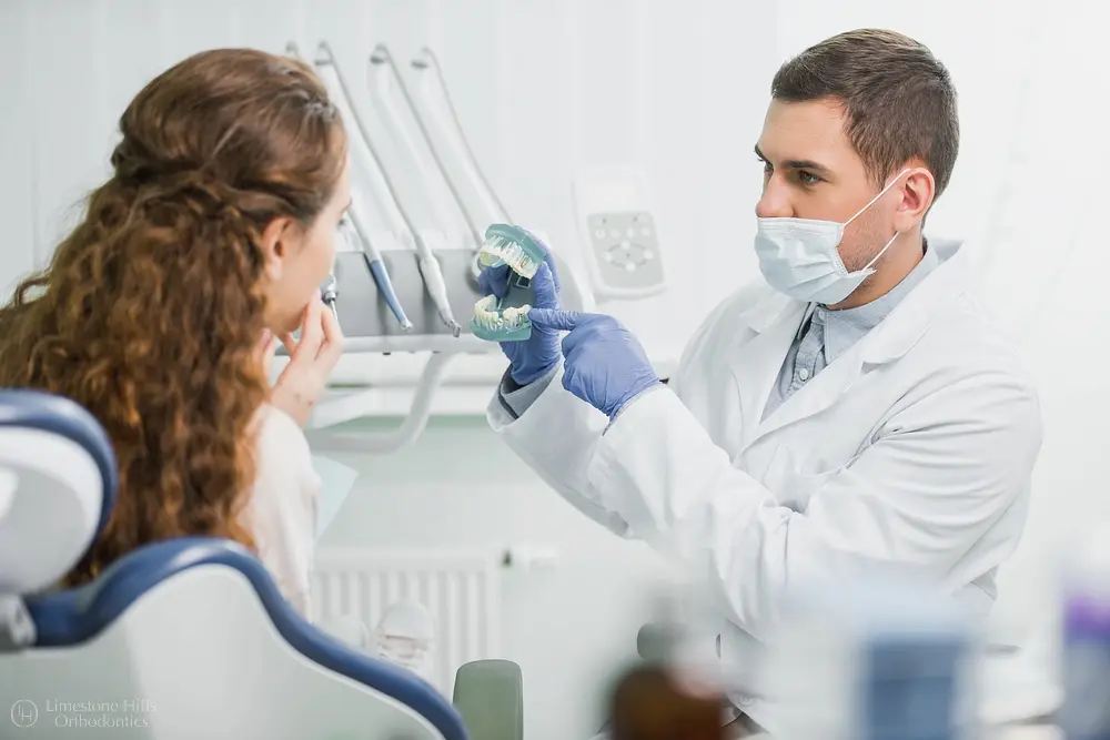 orthodontist showing x-ray image to patient - How TADs (Mini Implants) Works in Austin, TX