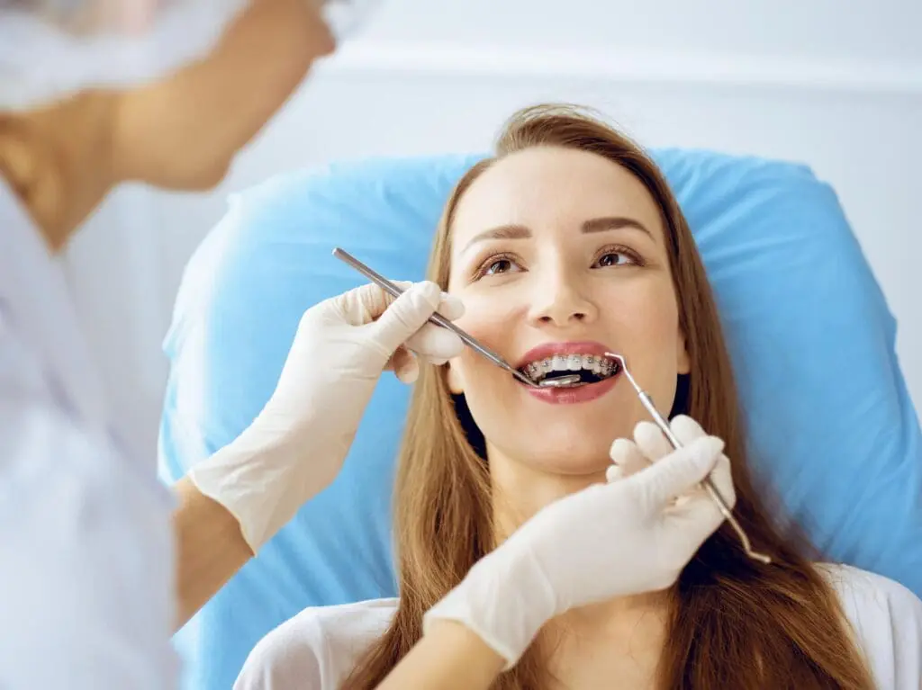 A young woman gets Teeth Gaps, Spacing Treatment, and Accelerated Orthodontic Treatment with braces at Limestone Hills Orthodontics in Austin, TX.